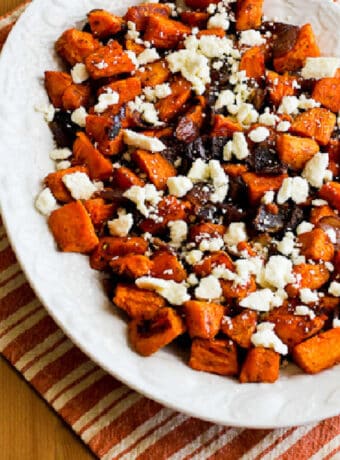Roasted Sweet Potatoes with Feta shown on serving platter with striped napkin