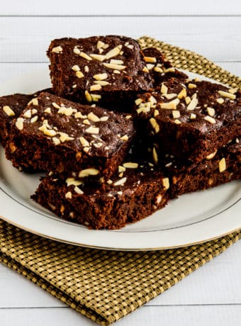 Almond Flour Brownies shown stacked on serving plate