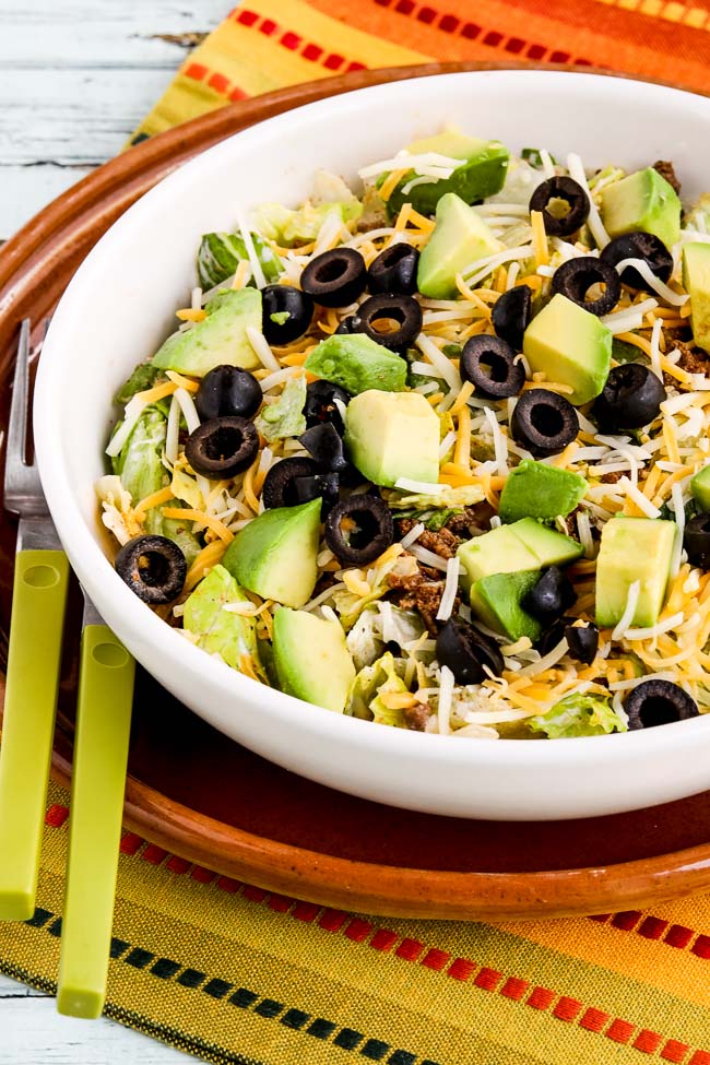 Perfect Low-Carb Taco Salad shown in serving bowl with avocado and olives on top