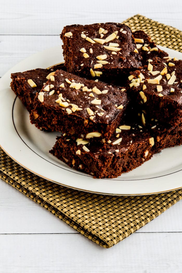 Almond Flour Brownies stacked on serving plate, farther away view