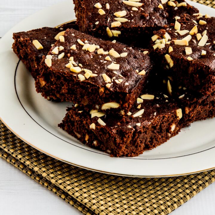Almond Flour Brownies stacked on serving plate, farther away view