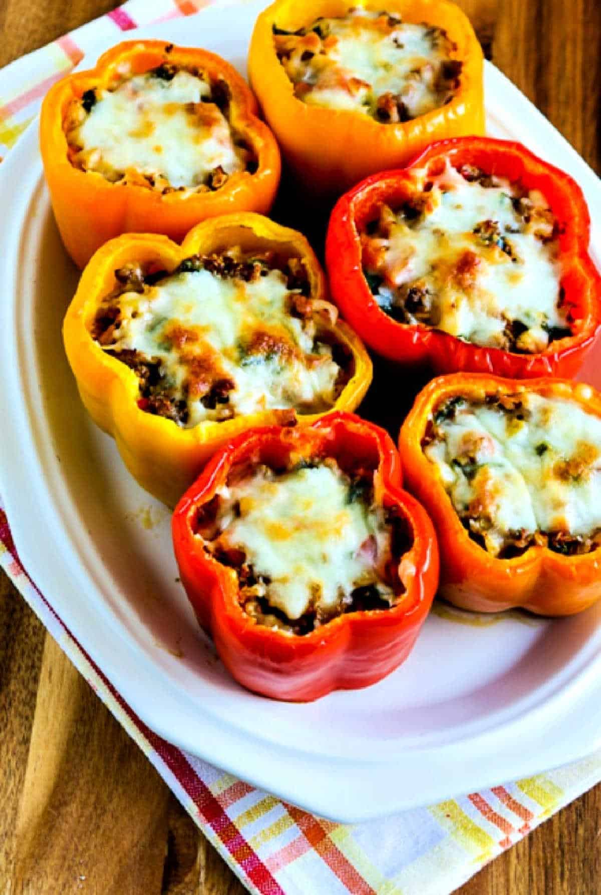 Cauliflower Rice Stuffed Peppers on serving plate with orange-yellow plaid napkin