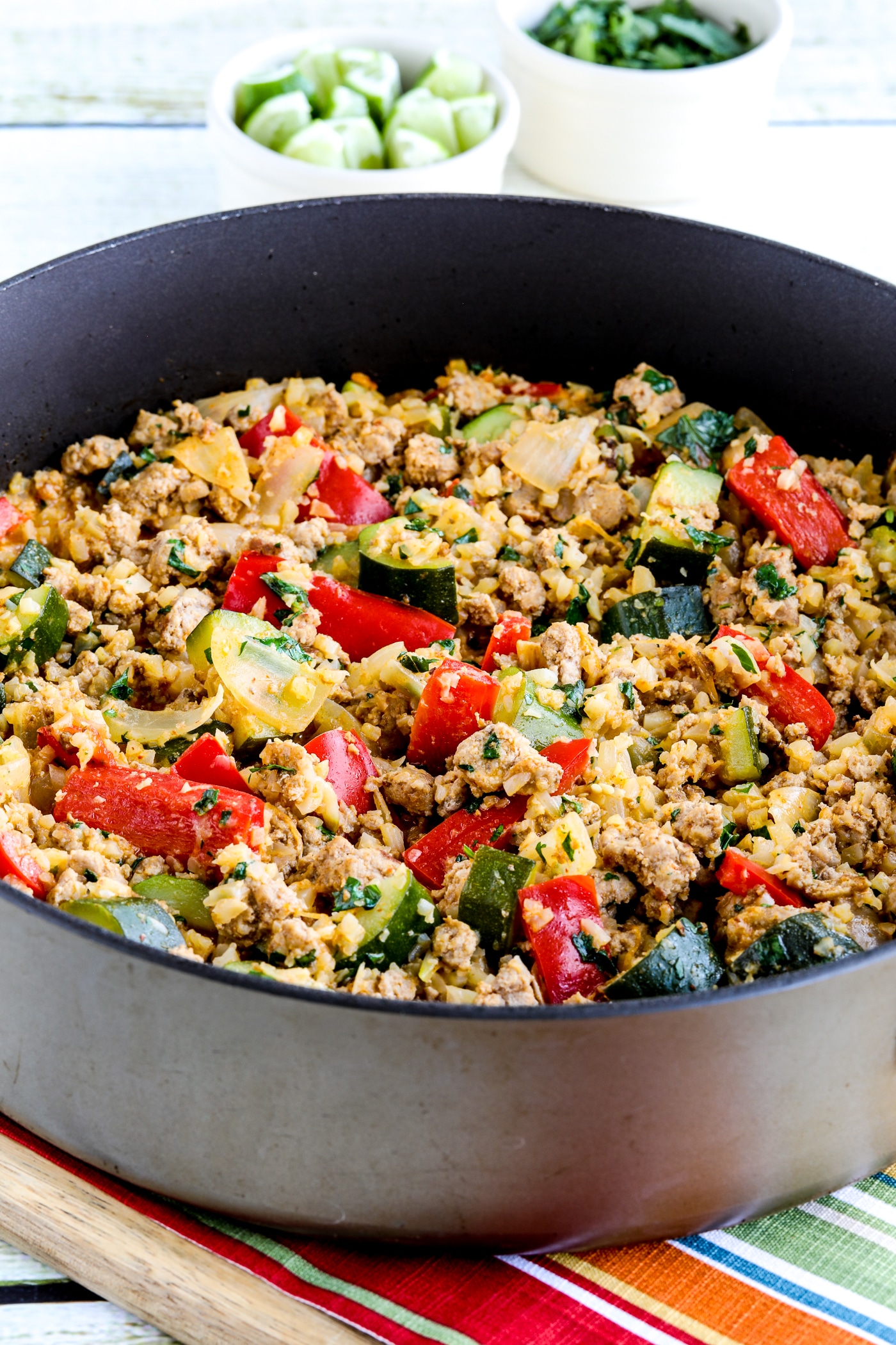 One-Pan Ground Turkey Curry shown in pan with limes and cilantro in background