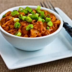 West African Chicken Stew in white serving bowl on plate