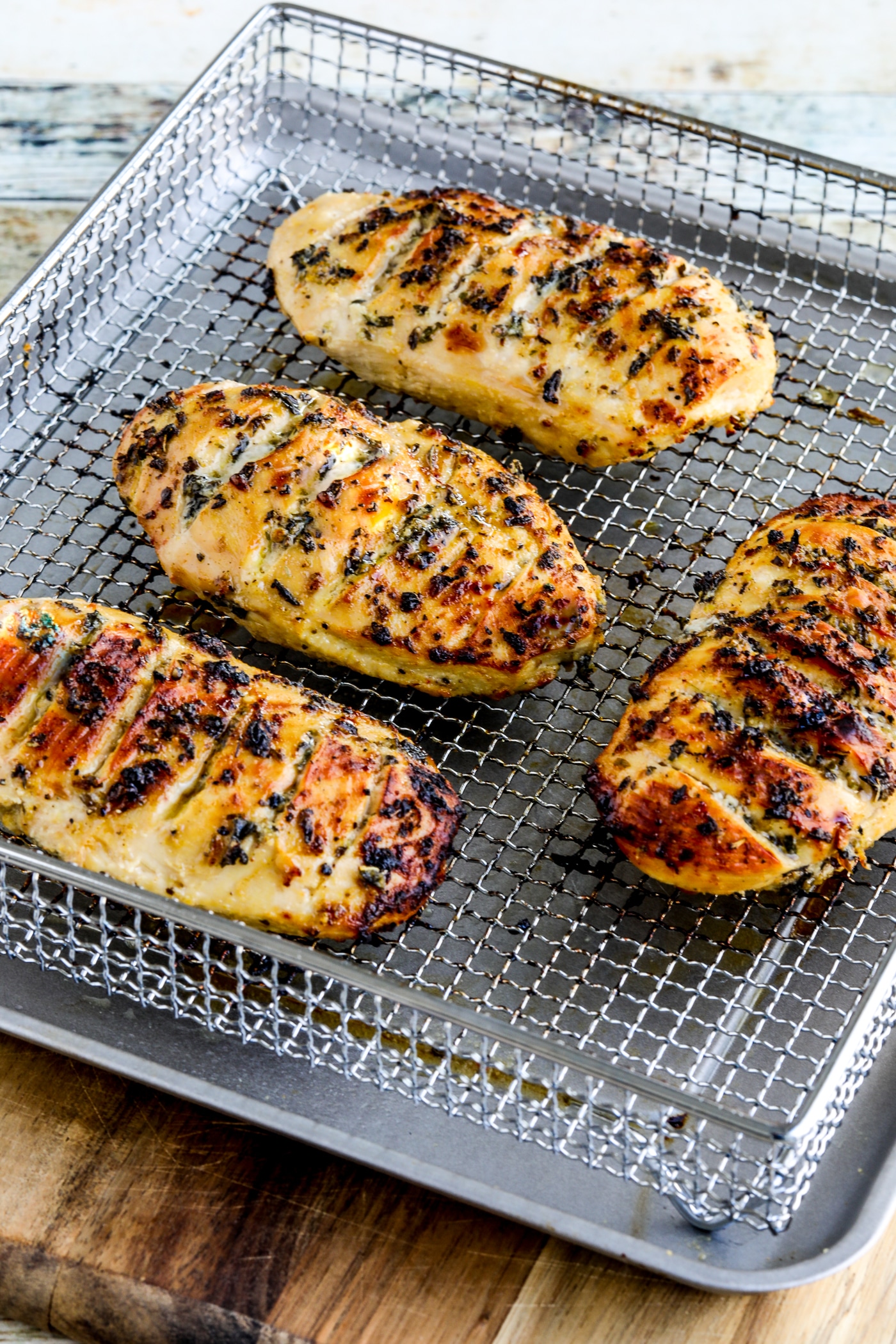 Air Fryer Marinated Chicken Breasts shown in Air Fryer basket