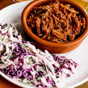 Low-Carb Instant Pot Pulled Pork shown on serving plate with slaw.