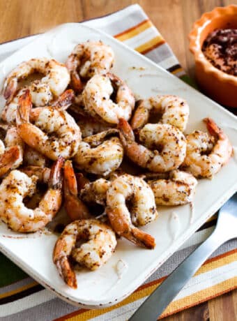 Spicy Baked Shrimp square image of shrimp on serving platter with yogurt-sumac dip in background.