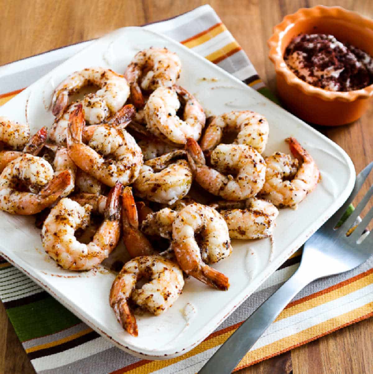Spicy Baked Shrimp square image of shrimp on serving platter with yogurt-sumac dip in background.
