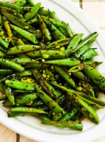 Square image for Spicy Stir-Fried Sugar Snap Peas showing them on serving plate.