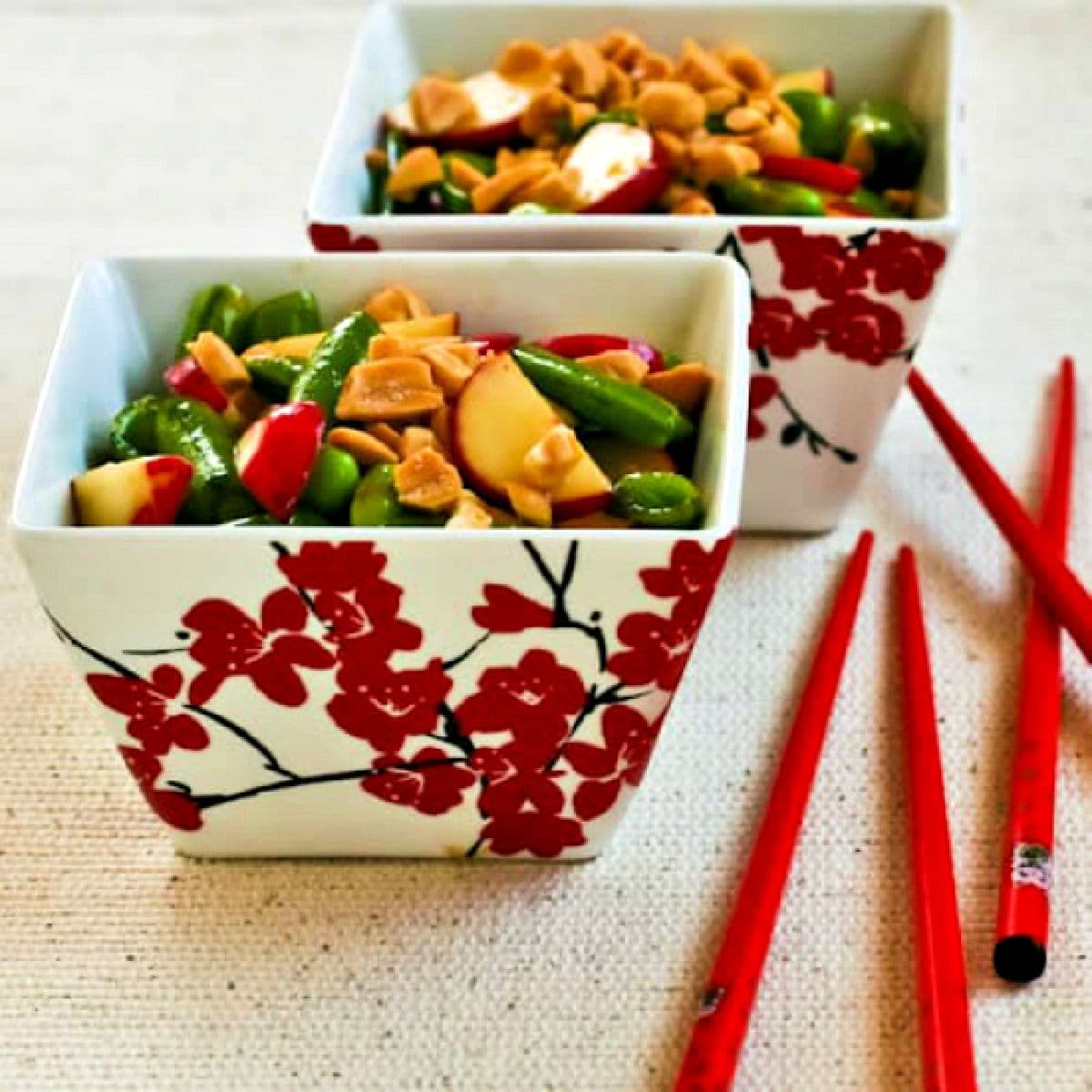 Sugar Snap Pea Salad shown in two serving dishes with chopsticks.