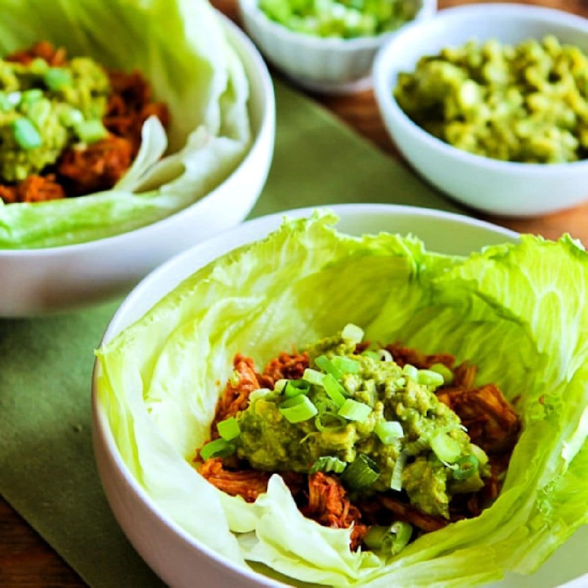 Square image of Slow Cooker Barbecue Chicken shown in lettuce cups.