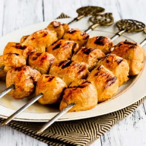 Square image of Asian Marinated Chicken Kabobs shown on serving platter.