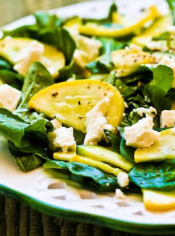 Square image of Raw Summer Squash Salad on serving plate.