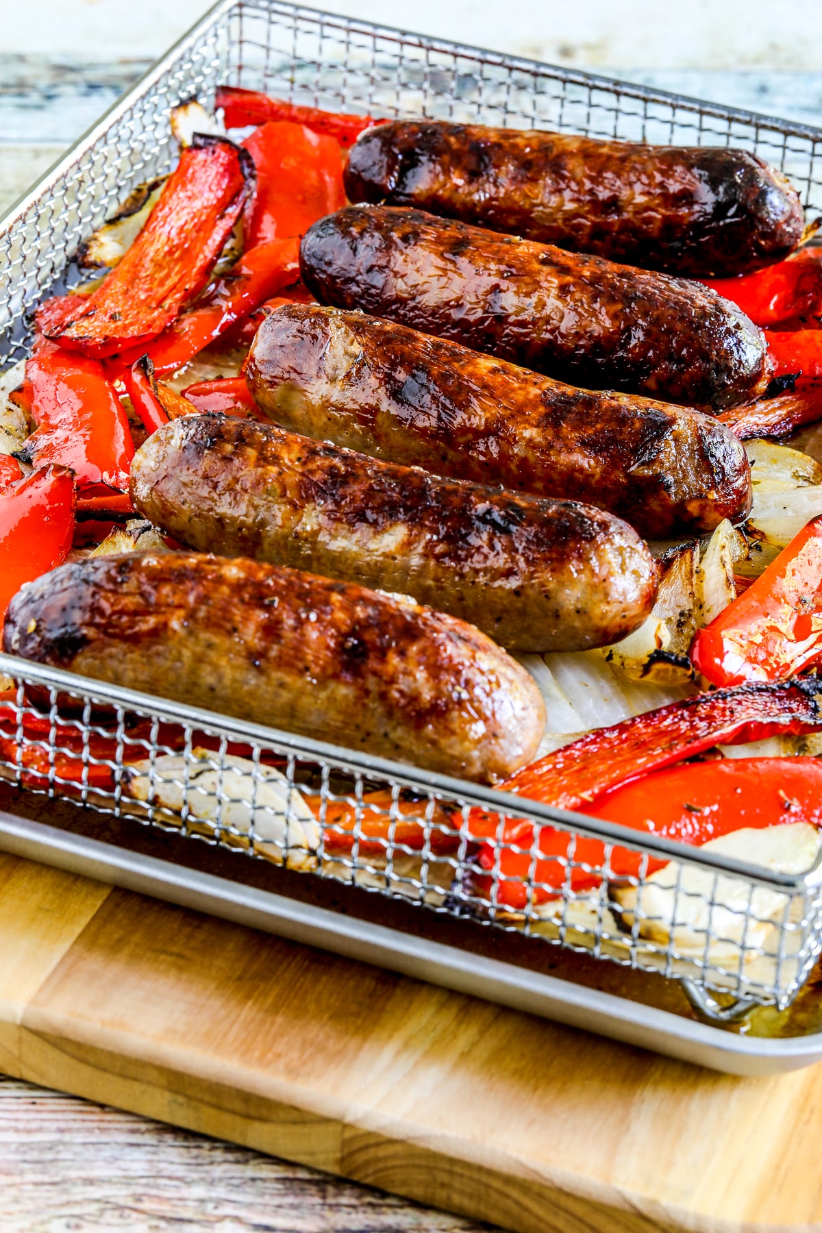 Air fryer sausage and pepper as shown in the air fryer basket after cooking
