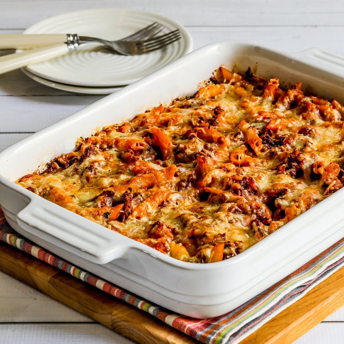 Baked Penne with Sausage square image of casserole in baking dish