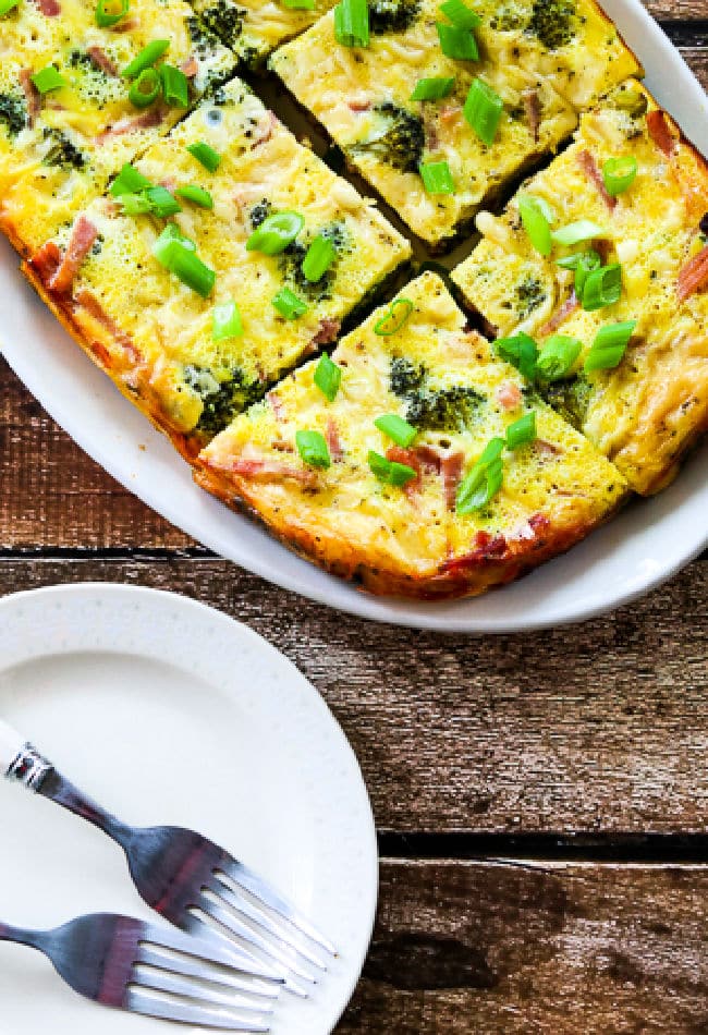 Slow Cooker Breakfast Recipe with Broccoli, Ham, and Swiss shown on serving plate.