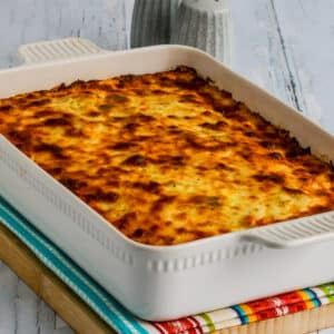 Square image of baked spaghetti casserole in baking dish.