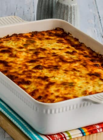 Square image of baked spaghetti casserole in baking dish.