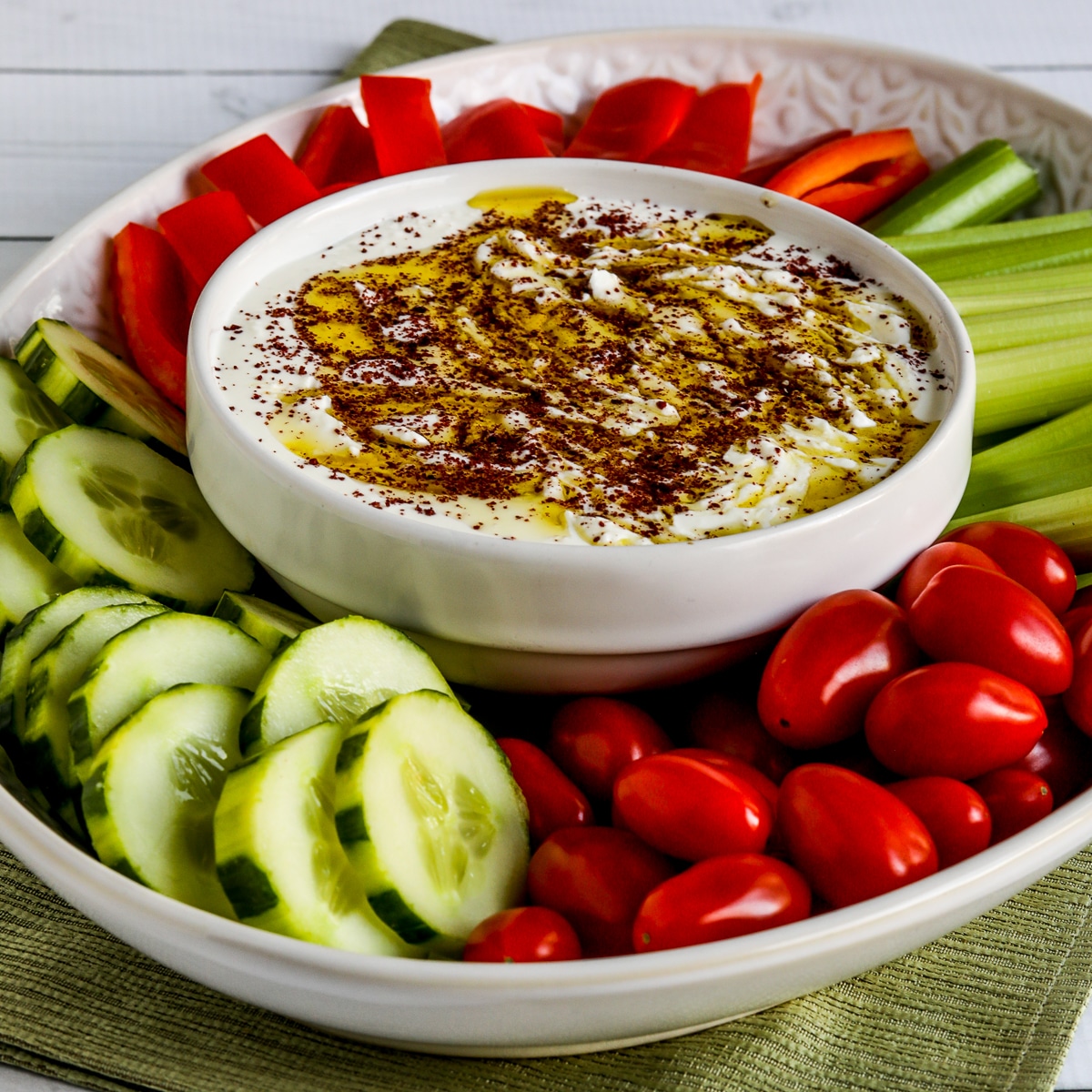 Whipped Feta Dip drizzled with olive oil, sprinkled with Sumac, and served with veggies