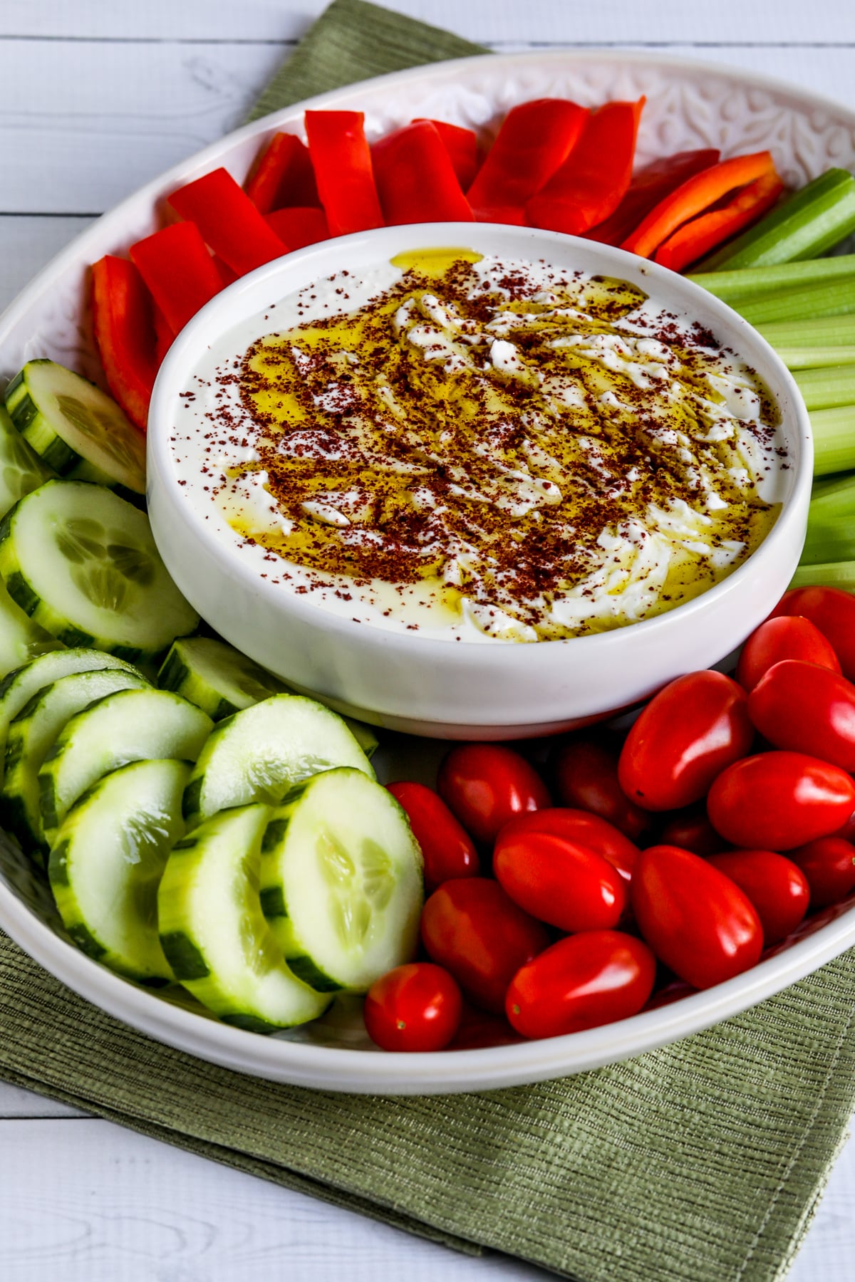 Served with vegetables on a serving plate with whipped feta dip and sumac