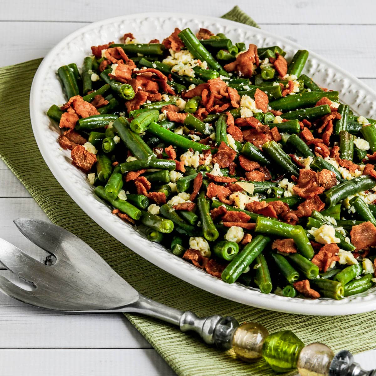 Square image of Instant Pot Green Beans with Bacon and Gorgonzola on serving plate
