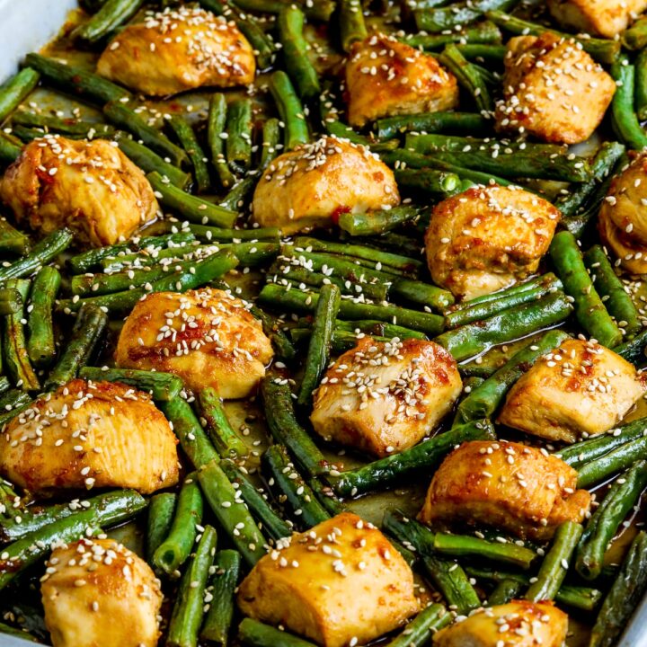 Asian Chicken and Green Beans Sheet Pan Meal shown on sheet pan with sesame seeds.