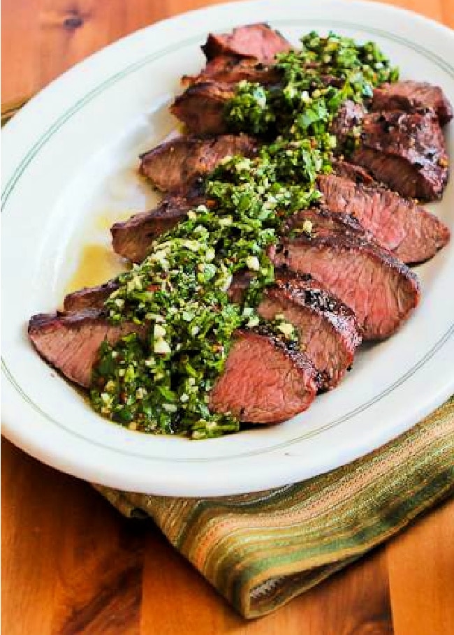 Steak with Chimichurri Sauce shown on serving platter.