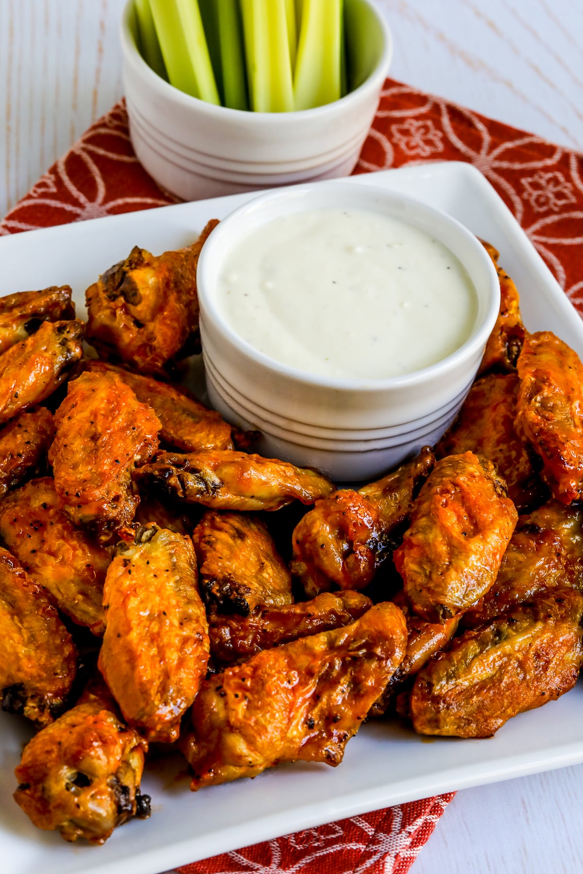 Air Fryer Buffalo Wings shown on serving tray with blue cheese dipping sauce.