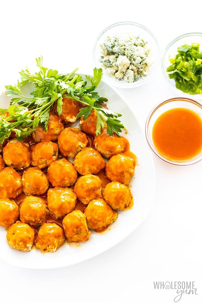 Keto Buffalo Turkey Meatballs from Wholesome Yum served with blue cheese and celery.