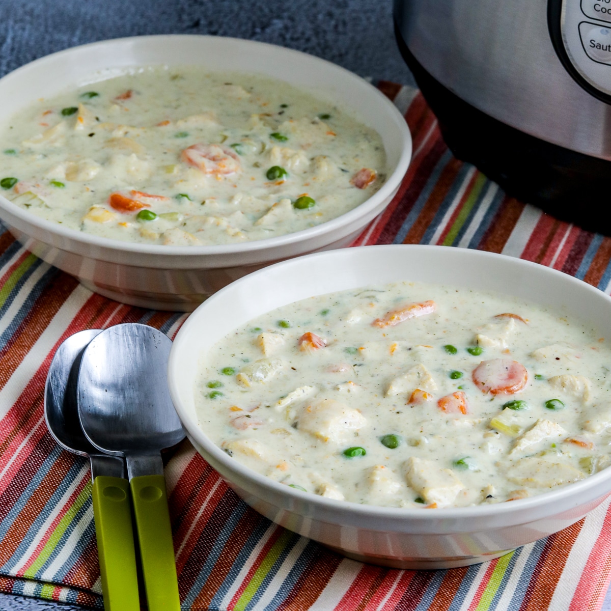 Square image for Instant Pot Chicken Pot Pie Soup in two serving bowls with Instant Pot in back.