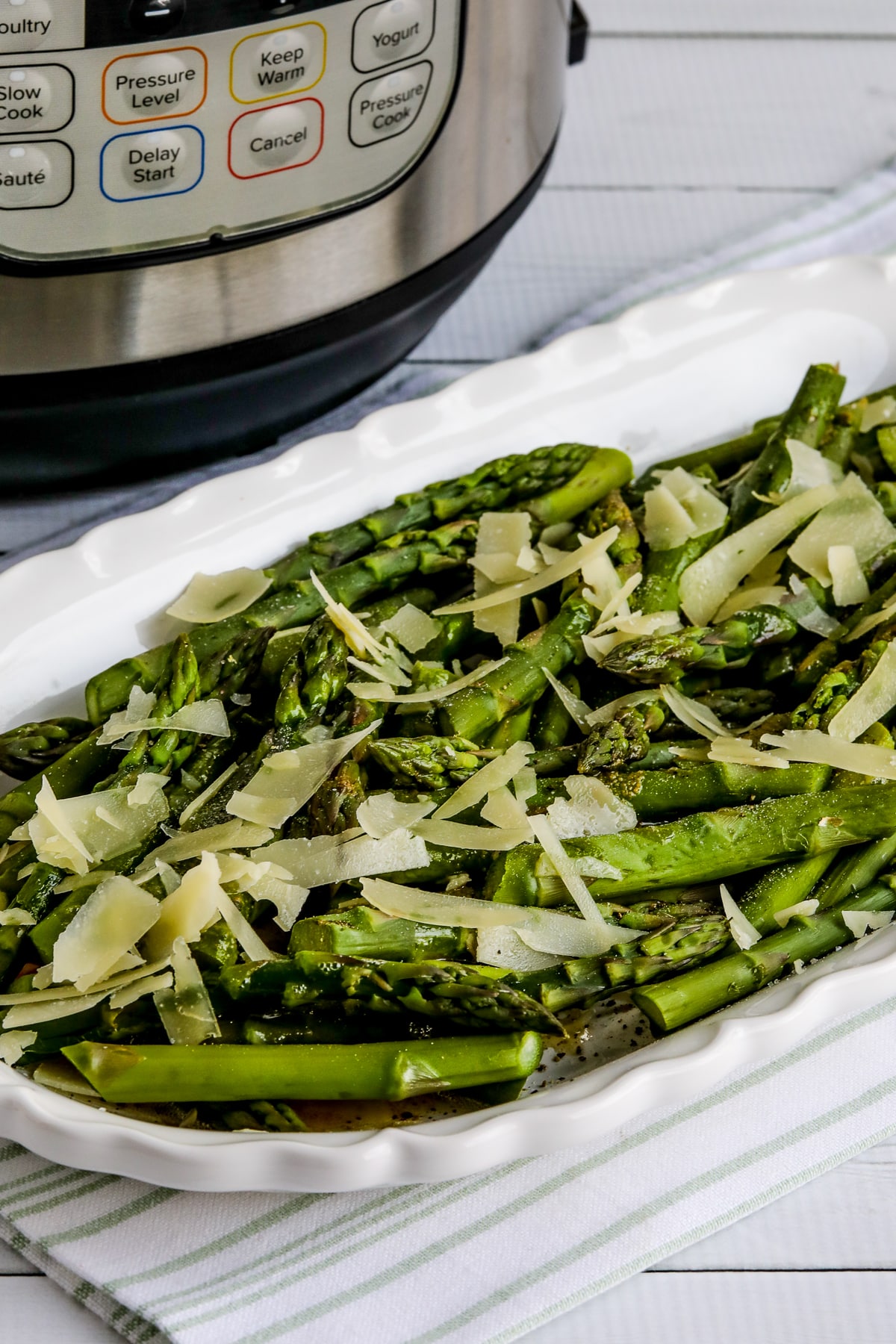 Instant Pot Asparagus on plage with asparagus with browned butter and Parmesan and Instant Pot in back.