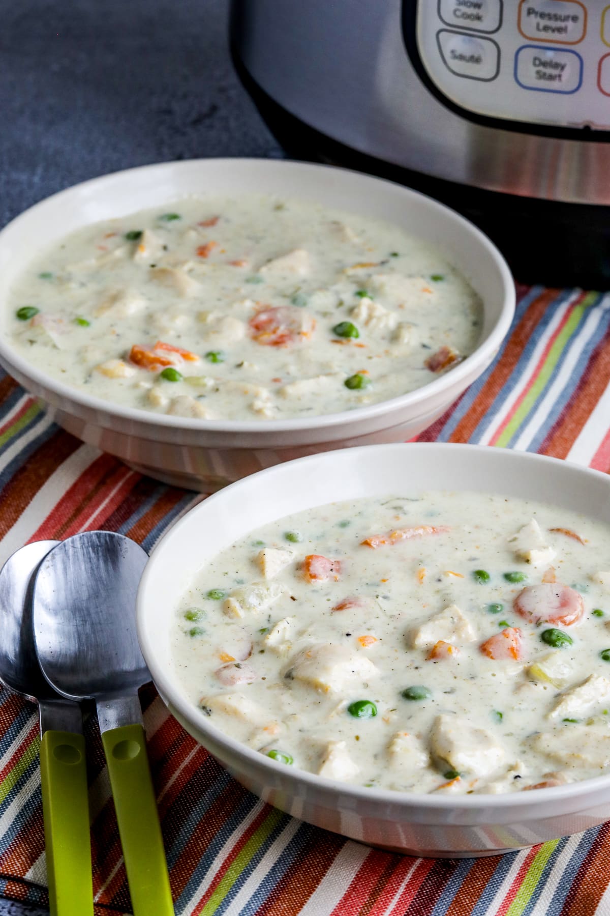 Instant Pot Chicken Pot Pie Soup in two bowls with Instant Pot in background.