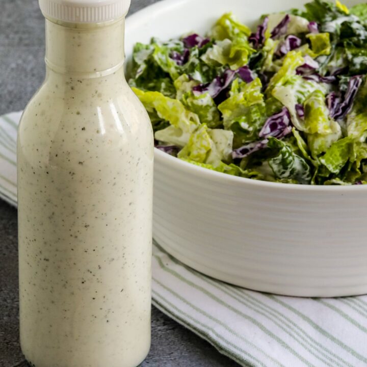BYU Creamery Ranch Dressing (Copycat Recipe) shown in bottle with salad with Ranch on the side.