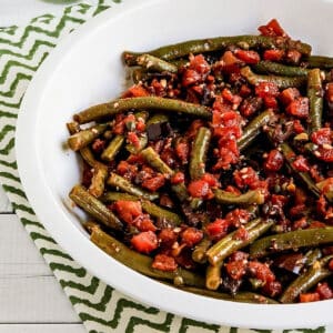 Square image for Green Beans with Tomatoes shown in serving bowl.