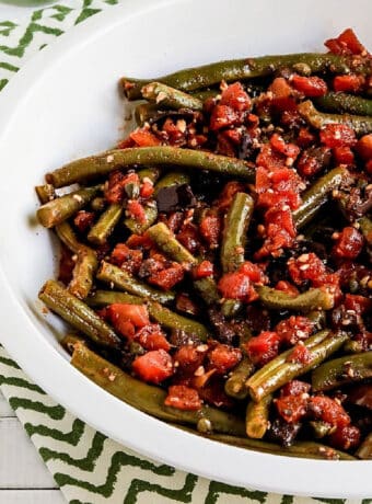 Square image for Green Beans with Tomatoes shown in serving bowl.