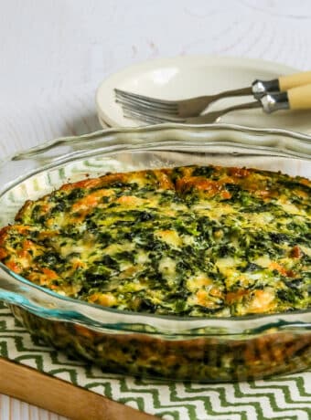 Square image of Crustless Spinach Quiche in baking dish.