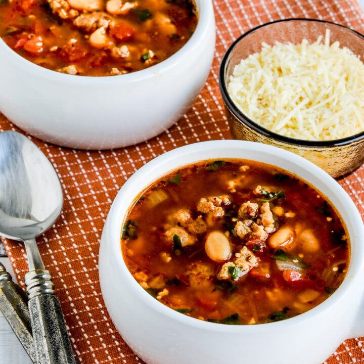 Cannellini Bean and Sausage Soup show in two bowls with Parmesan Cheese.