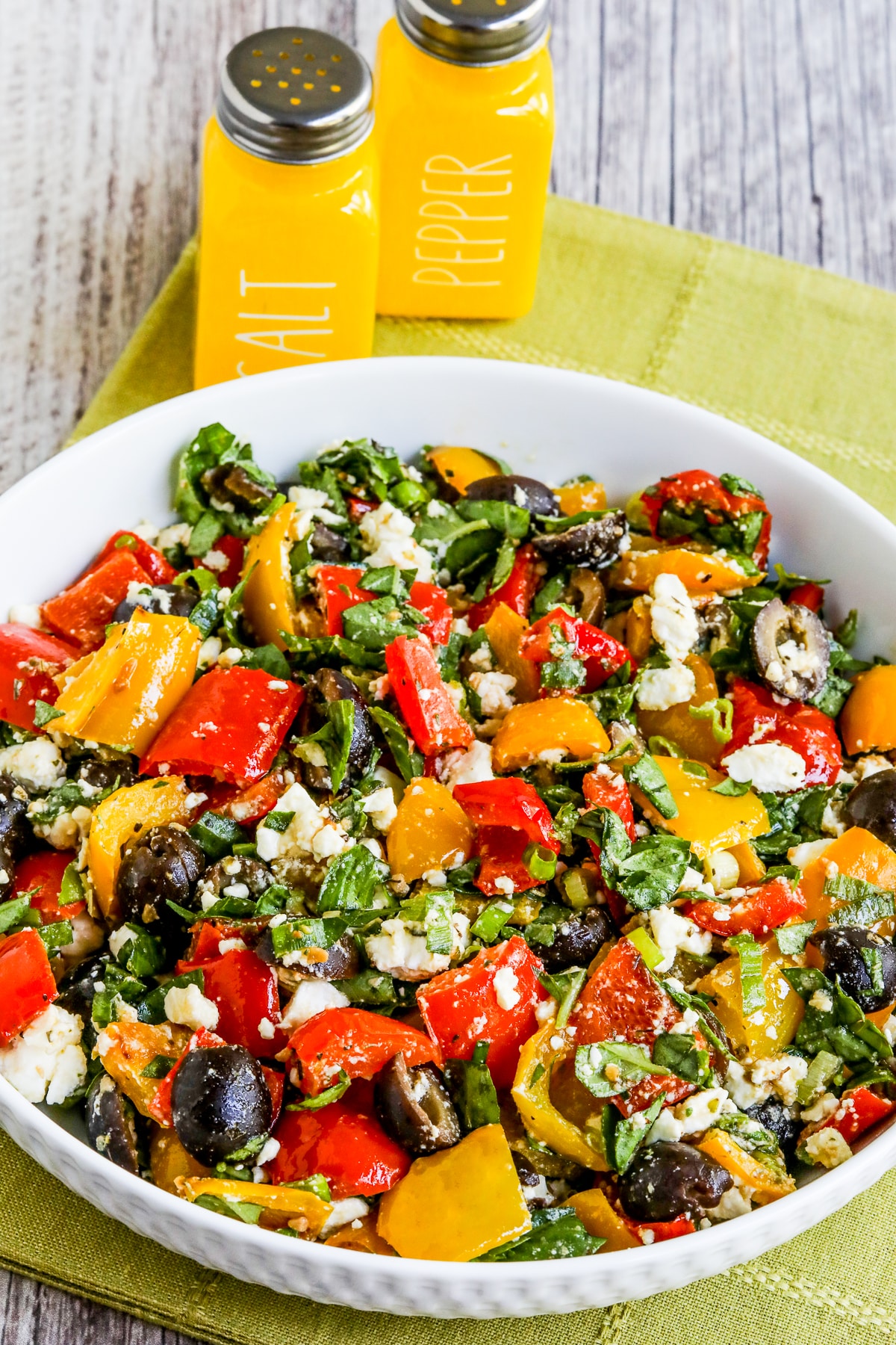 Roasted Pepper Salad shown in salad bowl with salt-pepper shakers in back.