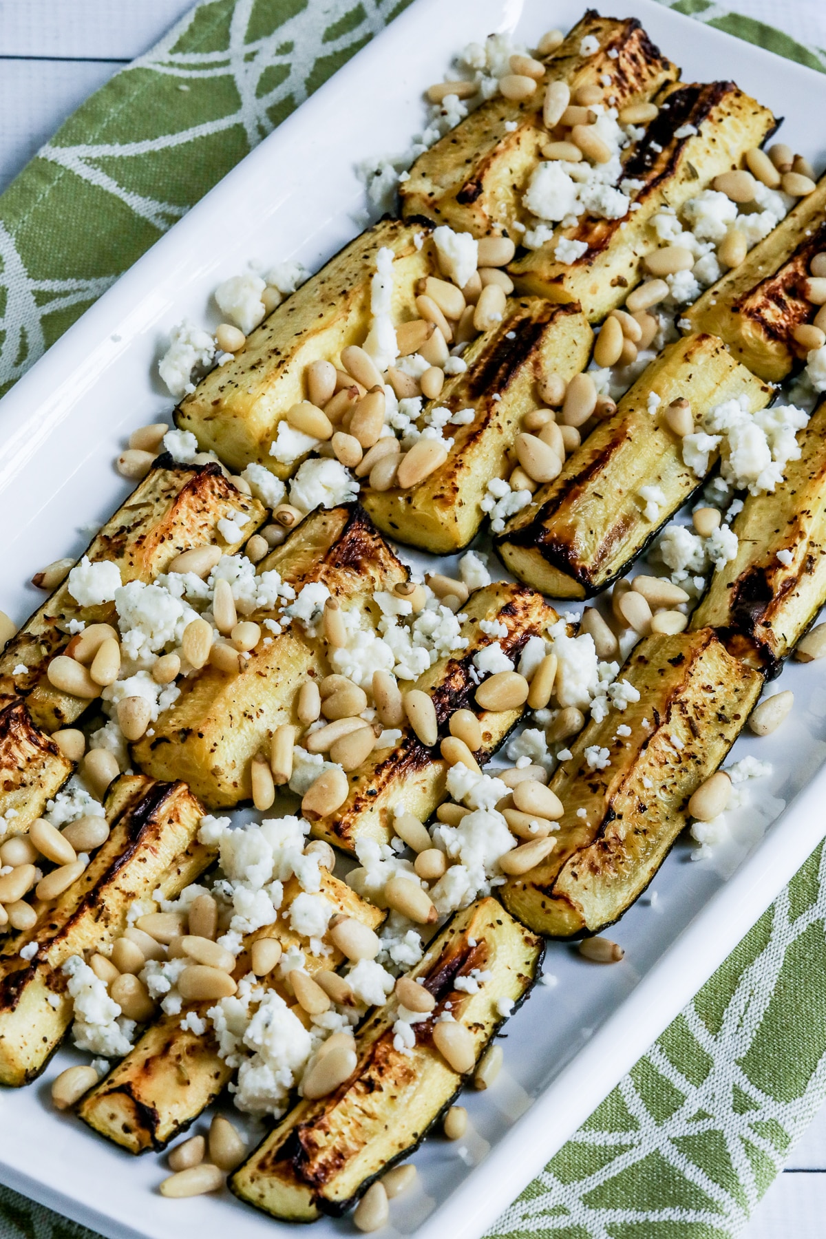 Air Fryer Zucchini with Gorgonzola and Pine Nuts shown on serving platter.