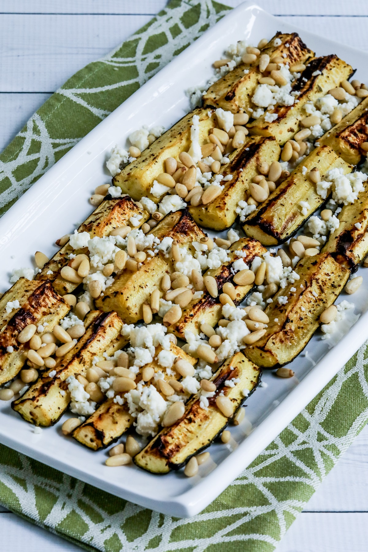 Air Fryer Zucchini with Gorgonzola and Pine Nuts on serving platter.